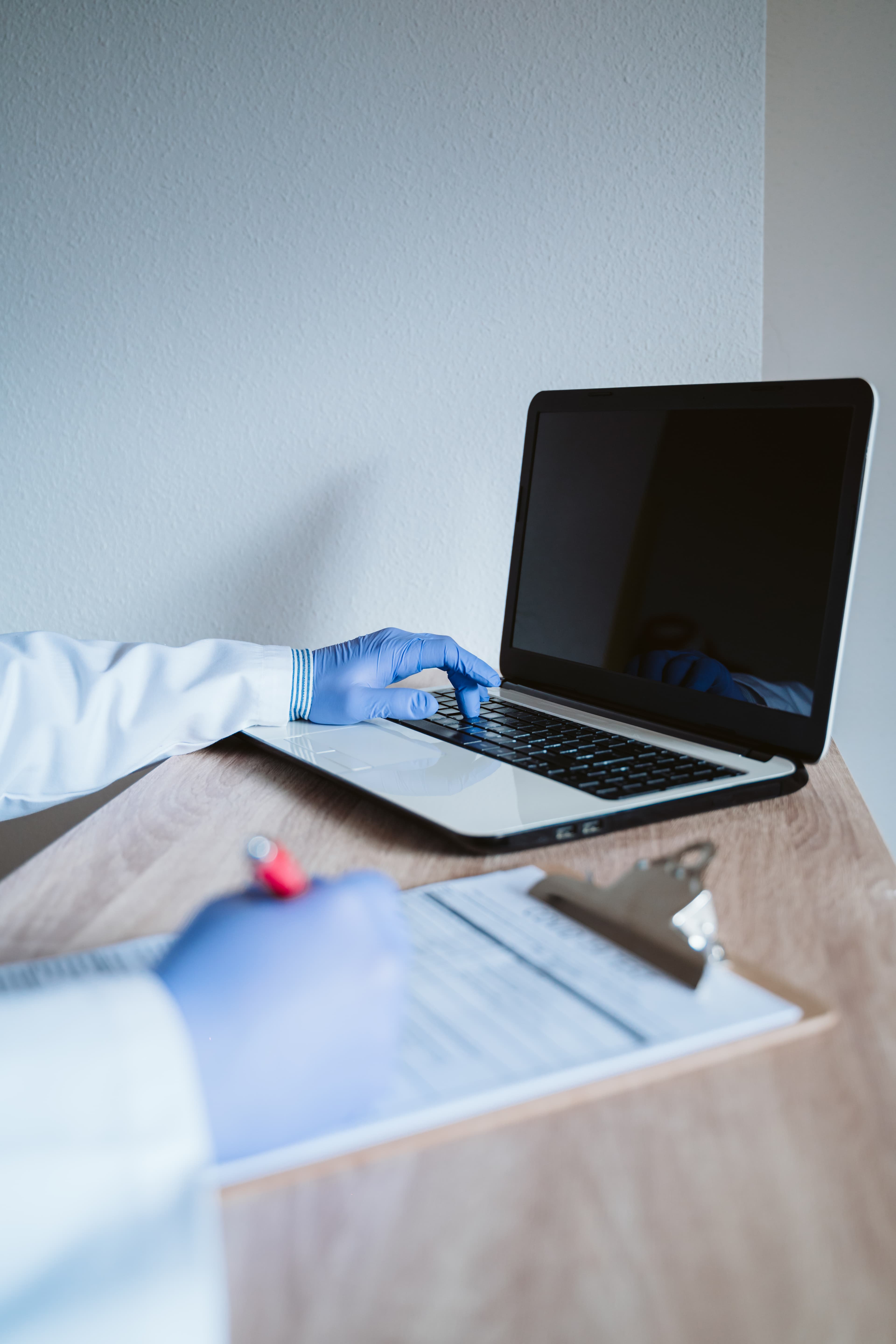 doctor-using-laptop-and-filling-out-medical-form-2026-01-05-23-29-06-utc.jpg